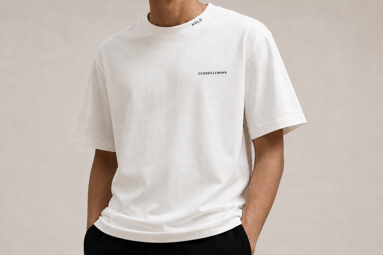 Model wearing the white HOLD Essential Tee with a subtle ISIN at the chest